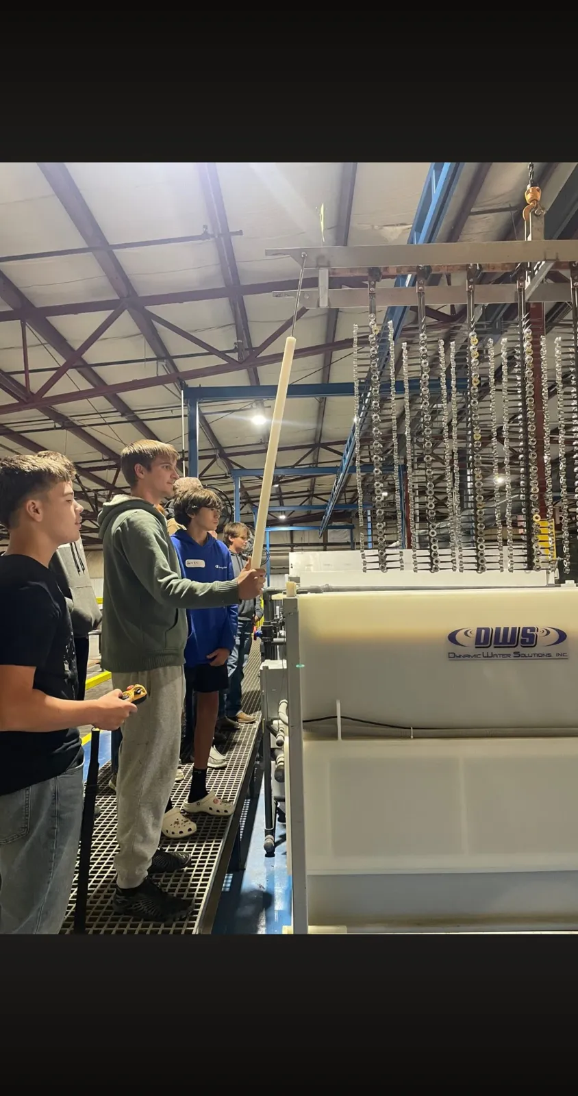 Students watching a demonstration at the anodizing tanks during a plant tour