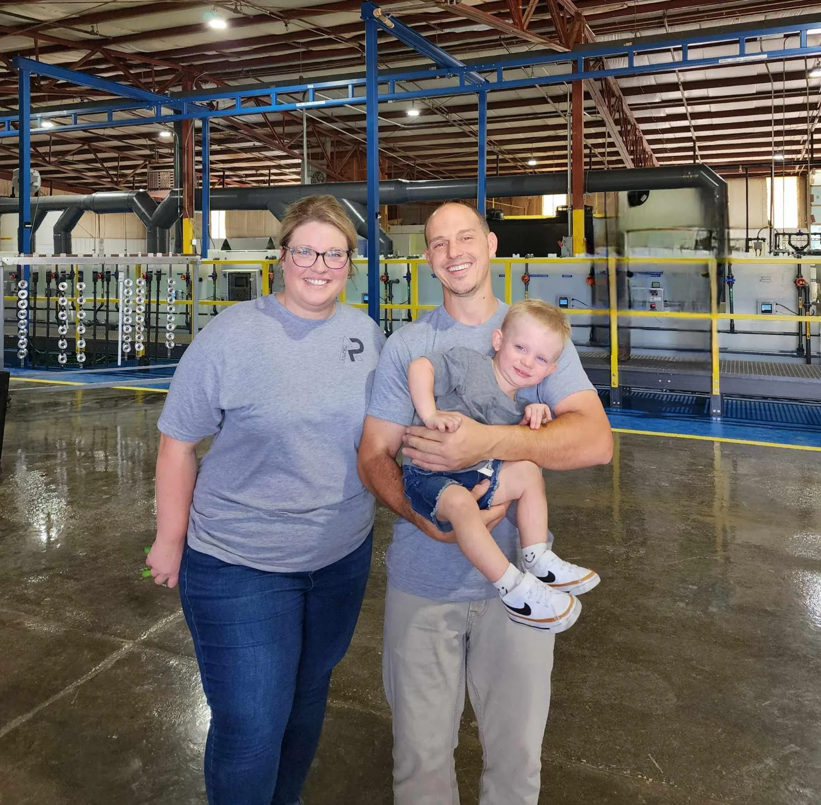 Matthew and Kendall Knight with their son on the AnoPRO plant floor